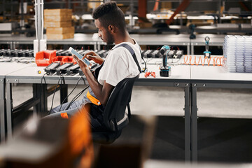 Wall Mural - african factory worker using tablet