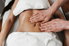 Beautiful Young Woman Receiving Professional Body Massage Treatment With Aromatherapy Essential Oil.