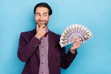 Poster - Photo of young guy hand touch chin think look empty space wonder profit benefit isolated over blue color background