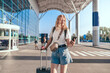 Young tourist woman with baggage in international airport