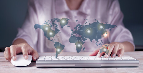 Wholesale and logistics concept. Woman using laptop in office, Illustration of a connected world map. in the foreground