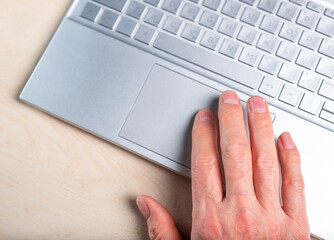 Aufkleber - Man hand on laptop. Using computer in work, education, online shopping, communication, for information search, relax. High quality photo