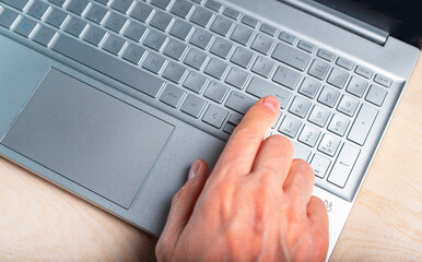 Poster - Man hand on laptop. Using computer in work, study, online shopping, communication. Digital technologies in common life concept. High quality photo