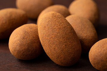 Wall Mural - Cinnamon and chocolate coated almonds.