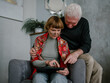 © Ksenia Krondo/Stocksy - Senior couple chatting in tablet smiling