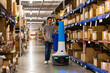 © Raymond Forbes LLC/Stocksy - Robot for picking merchandise orders in warehouse
