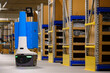 © Raymond Forbes LLC/Stocksy - Robot for picking in warehouse with tablet