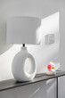 © Raymond Forbes LLC/Stocksy - Modern Lamp on table with light switch