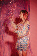 © Liliya Rodnikova/Stocksy - Dressy woman having fun with tinsel at party