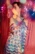 © Liliya Rodnikova/Stocksy - Dressy woman among sparkles