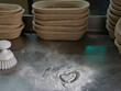 © Miquel Llonch/Stocksy - Baker working table with a flour draw heart