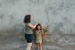 © Jimena Roquero/Stocksy - Woman adjusting painfully hair bun to a kid outdoors