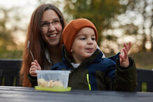 Mother And Son Eating Healthy Snack In A Park