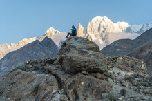 Man Sits On Rock And Looks At Himalaya Mountains