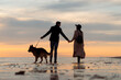 © Mauro Grigollo/Stocksy - Back view of a couple with a dog