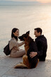 © Mauro Grigollo/Stocksy - Couple with their dog at the seaside