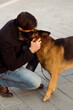 © Mauro Grigollo/Stocksy - Man kiss his dog outdoor