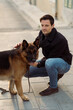 © Mauro Grigollo/Stocksy - Man with his dog on a walkway