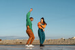 © Alba Vitta/Stocksy - Cool friends listening to music and dancing
