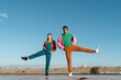 © Alba Vitta/Stocksy - Cool friends listening to music posing and dancing