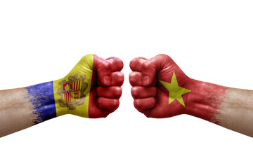 Two hands punch to each others on white background. Country flags painted fists, conflict crisis concept between andorra and vietnam