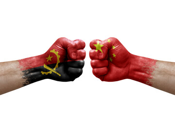 Two hands punch to each others on white background. Country flags painted fists, conflict crisis concept between angola and china