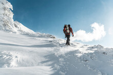 Mountain Explorer Hiking Alone On Snowy Mountain