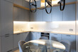 © Luciano Spinelli/Stocksy - Kitchen with the shelf and countertop lights turned on