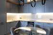 © Luciano Spinelli/Stocksy - Kitchen with the shelf and countertop lights turned on
