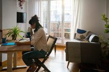 Asian Woman Drinking Coffee And Working From Home.