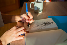 Closeup Of Hands Of A Designer Drawing On The Table