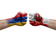 Two hands punch to each others on white background. Country flags painted fists, conflict crisis concept between armenia and gibraltar
