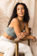 © Anna Tabakova/Stocksy - Woman in cozy sweatpants and sport bra smiling