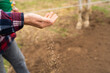 © Alba Vitta/Stocksy - Man sowing seeds in field
