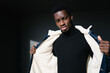 © Manu Padilla/Stocksy - Black guy opening warm jacket