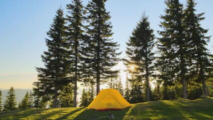 Wall Mural - Aerial view of tourist camping tent on mountain campsite at bright sunny evening. Active tourism and hiking concept