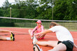© STUDIO TAURUS/Stocksy - Happy kids stretching after tennis practice outdoor