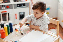 Child Learning To Paint