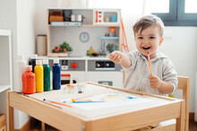 Happy Toddler With Paints