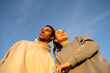 © Alba Vitta/Stocksy - Portrait of friends against blue sky