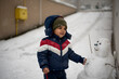 © Jelena Markovic/Stocksy - Toddler standing outdoor while snowing