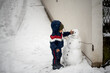 © Jelena Markovic/Stocksy - Toddler standing outdoor while snowing
