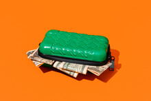 Some Dollar Banknotes In A Small Green Suitcase