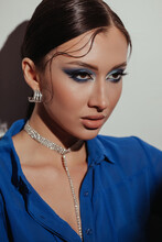Beauty Brunette With Blue Make Up Looking Away