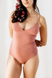 © Marc Bordons/Stocksy - A woman wearing pink bodysuit