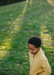 © Rob and Julia Campbell/Stocksy - Fun loving boy outside in grass