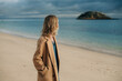 © Olga Moreira/Stocksy - Woman looking at the island in the sea