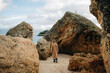 © Olga Moreira/Stocksy - Woman in the middle of rocks