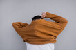 © Olga Kozicka/Stocksy - Pulling Sweater Over Head