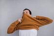 © Olga Kozicka/Stocksy - Pulling Sweater Over Head